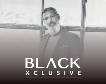 Black-xclusive poster with a man with white beards.